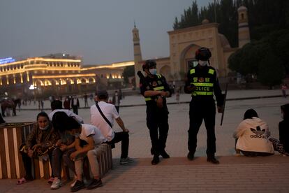 Two police officers stood guard outside a mosque in Kashgar, a city in China's Xinjiang region, on May 3.