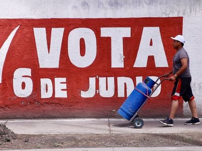 Transeúnte pasa frente a propaganda electoral en Ciudad de México. EFE/Carlos Ramírez