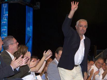 Javier Arena responde con un saludo al caluroso aplauso de los dirigentes del PP, en un momento de la convenci&oacute;n.