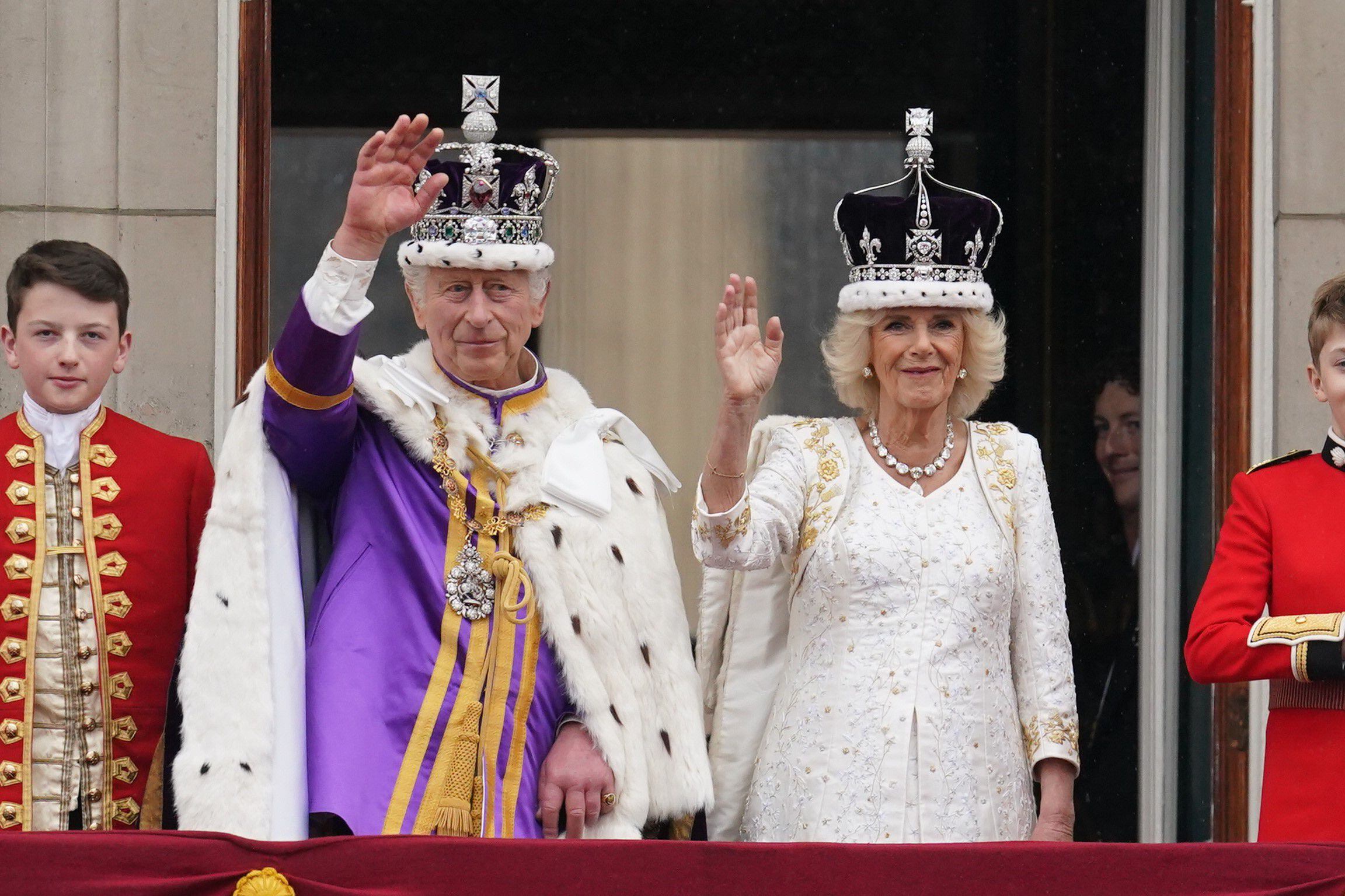 Carlos III y la reina Camila saludan desde el balcón del palacio de Buckingham. Los elegidos para salir al balcón son una muestra de la voluntad del rey de reducir al máximo el núcleo duro de la familia real británica. 