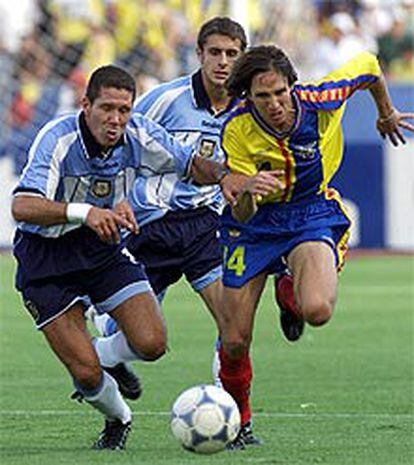 Simeone (Argentina) y Marlon (Ecuador) persiguen un balón con Aimar detrás.