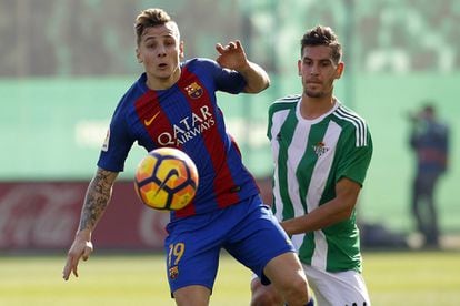 El jugador del Barcelona Digne (izquierda) controla el balón ante el jugador del Betis, Alex Alegría.