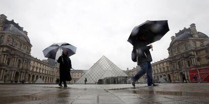 Dos turistas caminan cerca del museo del Louvre este martes en Par&iacute;s.