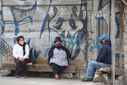 Three people protect themselves from the virus with masks, last July in Quito (Ecuador).
