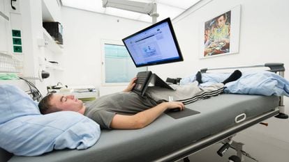 Un hombre usa un ordenador tumbado en una cama en las instalaciones en Colonia del Centro Aeroespacial
 Alemán.