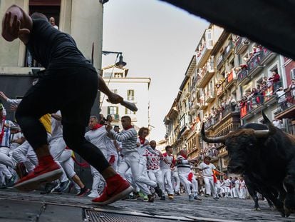 Los participantes corren delante de los toros durante el "encierro" de las fiestas de San Fermín en Pamplona, ​​norte de España.