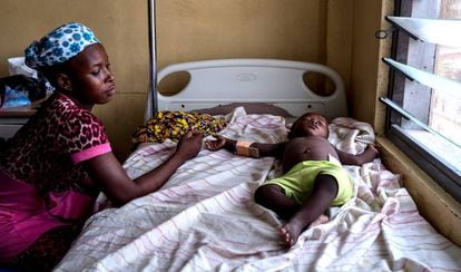 Abdul Latif duerme mientras su madre, Sherifa, vigila su sueño. El niño se recupera de la malaria en el hospital general de Maamobi, en Accra.