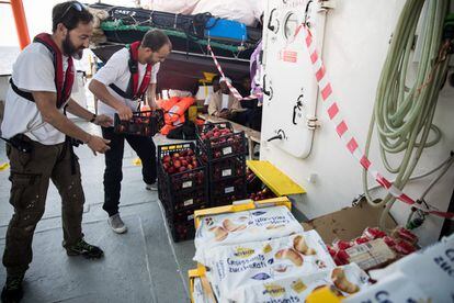 Trabajadores de MSF colocan los suministros recibidos por otra embarcación italiana en la cubierta del 'Aquarius', el 12 de junio de 2018.