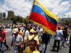 Opposition supporters holding a Venezuelan flag protest against Venezuela's President Nicolas Maduro's government during a rally in Caracas