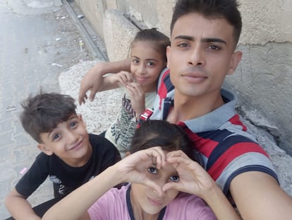 Abdallah Aljazzar, a 24-year-old Gazan, in a photo with his little brothers, the same one he used to raise funds to go to Australia.