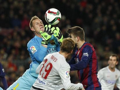 Ter Stegen trata de blocar un balón ante la presencia de Torres y Piqué.