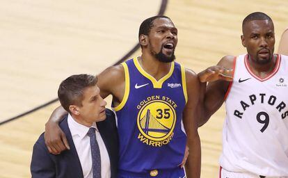 Kevin Durant, tras su lesión, se retira acompañado por Ibaka.