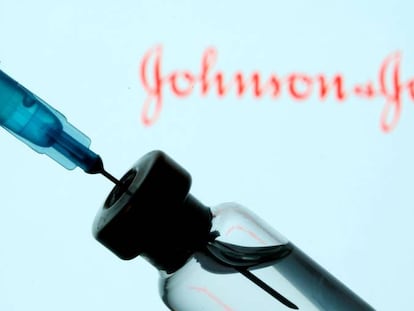 FILE PHOTO: Vial and sryinge are seen in front of displayed Johnson&Johnson logo in this illustration taken