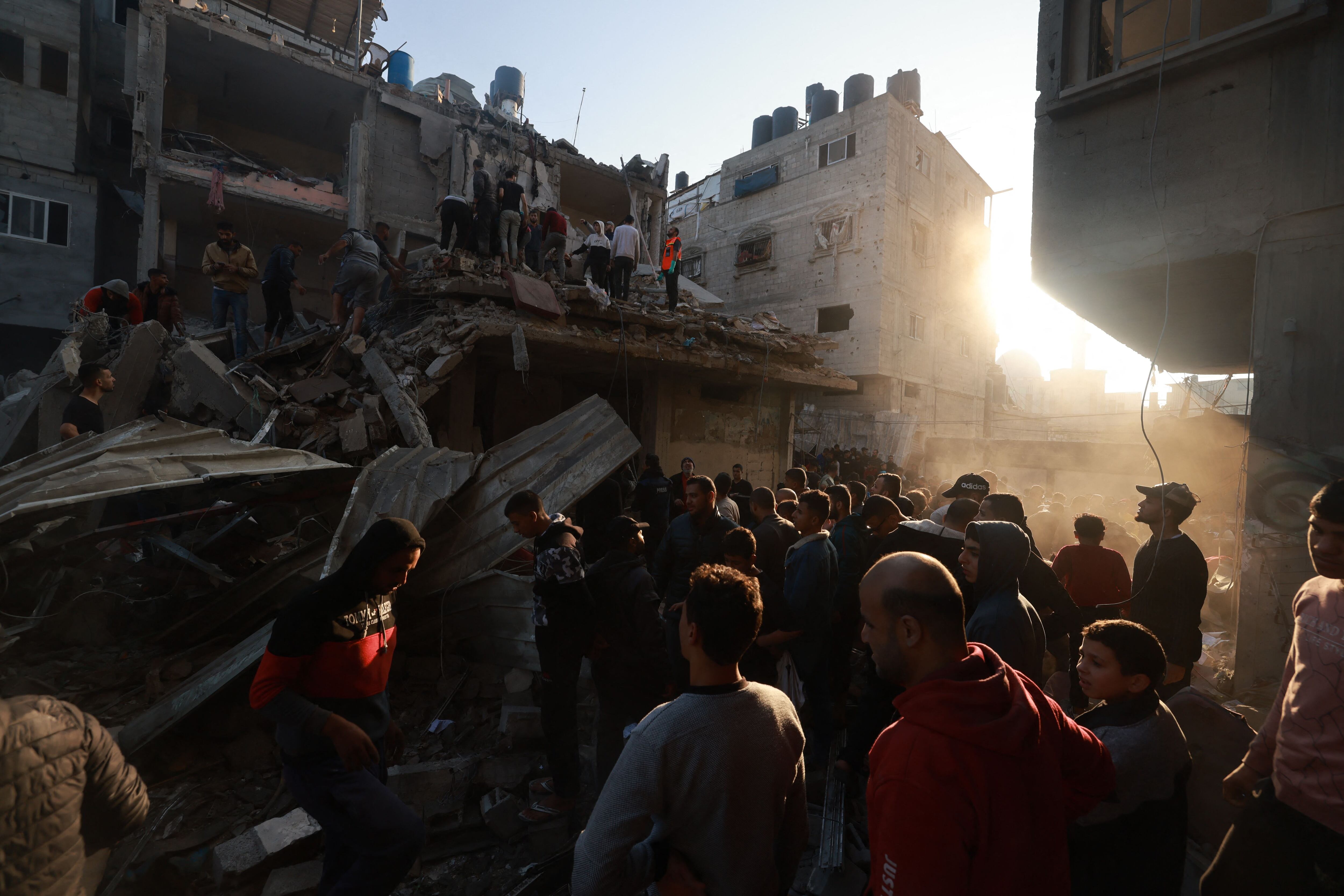 EDITORS NOTE: Graphic content / Palestinians inspect the destruction following an Israeli air strike on the Rafah refugee camp in the southern Gaza Strip on December 1, 2023, as fighting resumed shortly after the expiration of a seven-day truce between Israel and Hamas militants. A temporary truce between Israel and Hamas expired on December 1, with the Israeli army saying combat operations had resumed, accusing Hamas of violating the operational pause. (Photo by MOHAMMED ABED / AFP)
