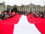 Demonstrators carry a giant Peruvian flag during a protest against the government of Peru's President Pedro Castillo in Lima, Peru August 22, 2021. REUTERS/Sebastian Castaneda