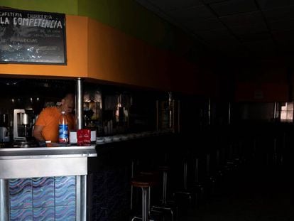 Un empleado trabaja sin luz en un bar de Santa Cruz de Tenerife. En vídeo, testimonio de otros afectados.
