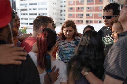 SinVergüenza members embrace during a rehearsal. 