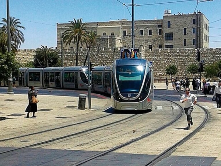 Image of the tram currently in service as it passes through the historic center of Jerusalem.