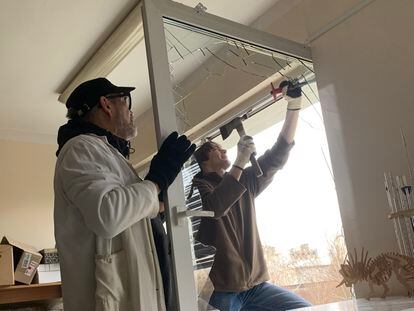 Two people repair the damage in Natalia Gerasimenko's laboratory.