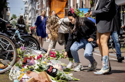 Tres jóvenes dejan flores este miércoles en lugar donde fue tiroteado en Ámsterdam el periodista holandés Peter R. de Vries.