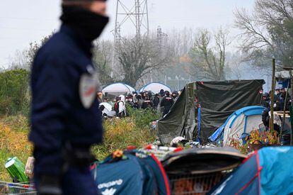 Un policía vigila el desmantelamiento de un gran campamento de inmigrantes en la localidad costera francesa de Grande-Synthe, este martes.