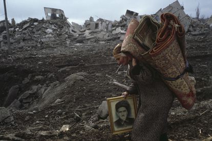 A woman leaves Grozny in February 2000.