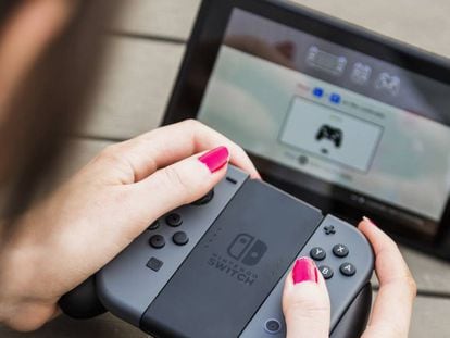 Una mujer juega a la Nintendo Switch con un control inalámbrico.