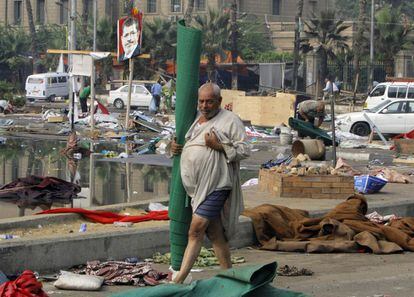 Un hombre camino entre los restos del campamento de protesta de la plaza de Nahda. Egipto afronta una nueva fase de incertidumbre tras la jornada sangrienta de este miércoles.