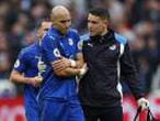 Leicester City's Yohan Benalouane is escorted off the pitch by medical staff after a challenge by West Ham United's Andy Carroll