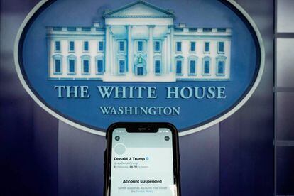 FILE PHOTO: A photo illustration shows the suspended Twitter account of former U.S. President Donald Trump on a smartphone at the White House briefing room in Washington