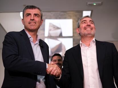El secretario general de Coalición Canaria, Fernando Clavijo (derecha), y el líder del PP en la región, Manuel Domínguez, se dan la mano este martes en Las Palmas de Gran Canaria tras haber cerrado un pacto para el gobierno regional.