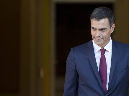 Spain's Prime Minister Pedro Sanchez steps out of the Moncloa Palace in Madrid, Spain, Wednesday, Sept. 12, 2018. Sanchez, who became prime minister in June promising to root out corruption, lost a culture minister over a tax fine and Spain's health minister resigned Tuesday over irregularities found in her master's degree. His center-left government has been marred by erratic policy-making, with several U-turns on cabinet decisions. (AP Photo/Paul White)