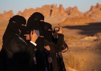 Several women with mobile phones in Al Madinah, Saudi Arabia, in December 2019.