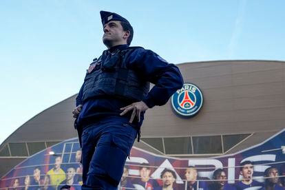 A police officer patrols outside the Parque de los Principes stadium, before the start of the match between Paris Saint-Germain and Barcelona.