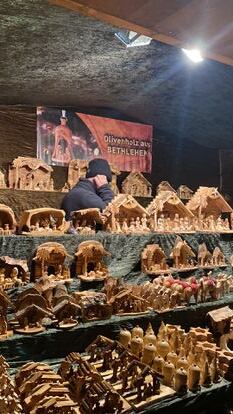 Among all the craft stalls there is one that catches my attention because of its simplicity.  Bethlehem, nativity scenes made with wood from Bethlehem, the inscription on it says. 