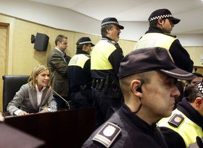 Agentes de la Policía Municipal forman una barrera de protección alrededor de la ex alcaldesa popular de Pinto, Miriam Rabaneda.