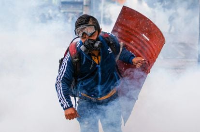 A young man runs during a protest on May 28, 2021.