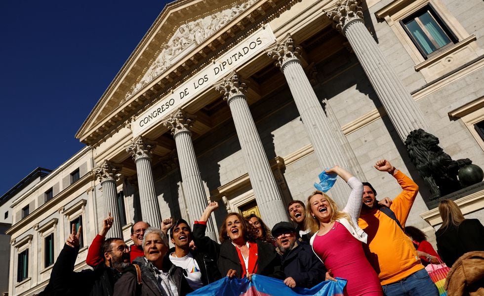 LGBT activists celebrate after the final approval of a law that will make it easier for people to self-identify as transgender, outside Spain's Parliament in Madrid, Spain, February 16, 2023. REUTERS/Susana Vera