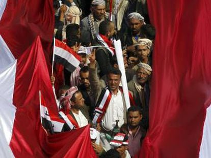 Un grupo de yemen&iacute;es sujetan una bandera gigante, durante las marchas en San&aacute;.