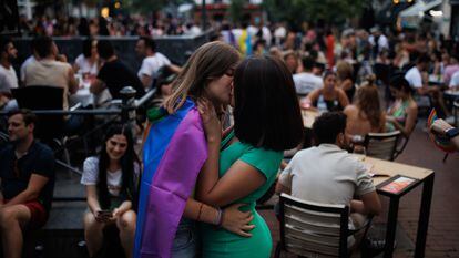 Dos chicas se besan durante las fiestas del Orgullo, en el barrio de Chueca (Madrid).
