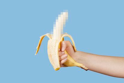 Hidden censored banana in hand on a blue background. Horny (aroused) penis, male erection and sexual education. Funny pornography