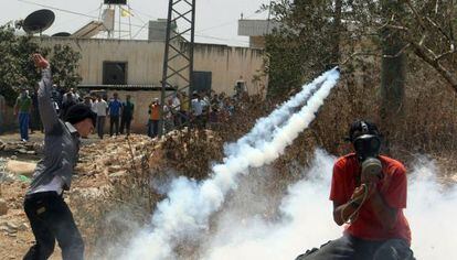 Varios palestinos protestan bajo el gas lacrimógeno por la expropiación de tierras para una colonia cerca de Nablus.