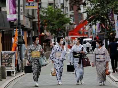 Unas mujeres pasean en Tokio con el traje tradicional de 'geisha', en julio.