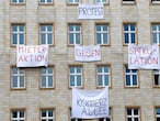 FILE PHOTO: Banners hang from an apartment block on Karl Marx Allee in Berlin, Germany, November 20, 2018, to protest against plans to sell flats on a boulevard of imposing Stalinist architecture that was one of the flagship building projects of the former German Democratic Republic after World War Two. Banners read "capitalist avenue" and "tenants action against speculation". Picture taken November 20, 2018.     REUTERS/Joachim Herrmann/File Photo