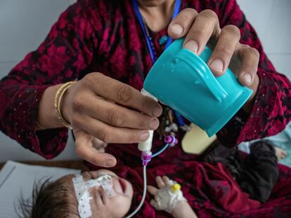 Zakia, de un mes y medioy con desnutrición aguda grave con complicaciones, está siendo alimentada por su madre con leche terapéutica en el Centro de Alimentación Terapéutica del Hospital Regional de Herat, en Irak.