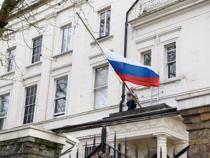 Un hombre recoloca la bandera de Rusia en el consulado ruso de Londres este mi&eacute;rcoles 14 de marzo. 