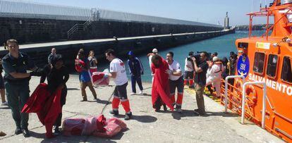 Voluntarios de Cruz Roja y guardias civiles atienden a los inmigrantes rescatados este s&aacute;bado por Salvamento Mar&iacute;timo.