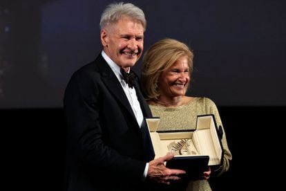 Harrison Ford, with the president of the Cannes Film Festival, Iris Knobloch, and his honorary Palme d'Or.