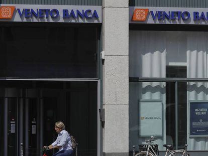 Una mujer pasa delante de una oficina de Veneto Banca en Mil&aacute;n