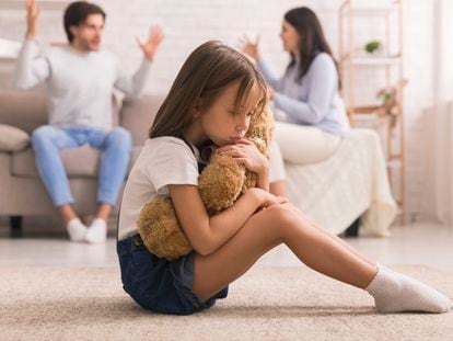Family Problems. Cute Little Girl Suffering From Parents Arguing, Sitting On Floor With Teddy Bear, Feeling Abandonned And Lonely